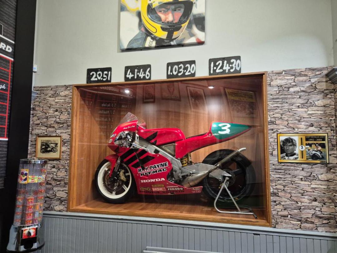 A number 3 racing Honda in Joey's colours in a glass case