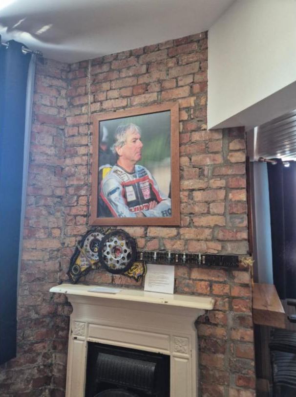A portrait of Joey over the fireplace