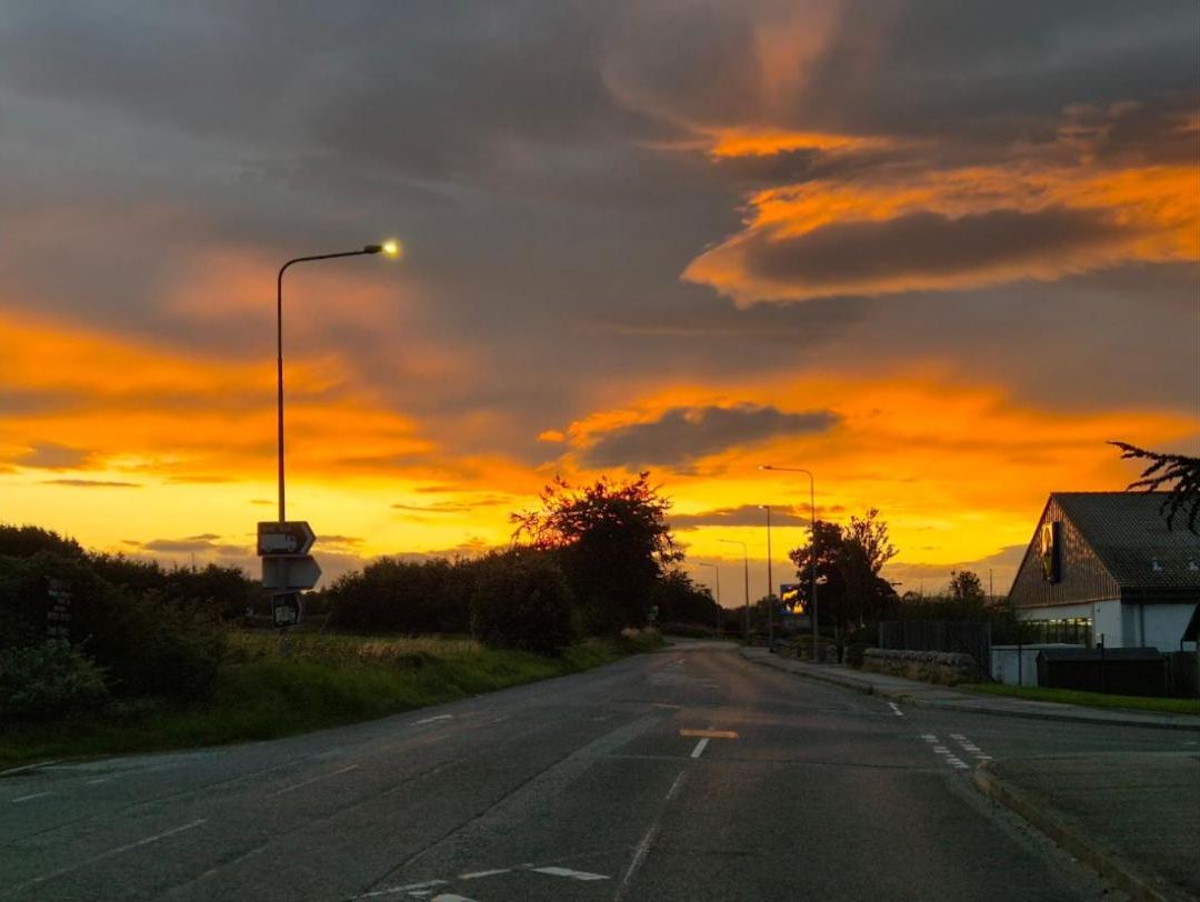 The sky on fire over the road
