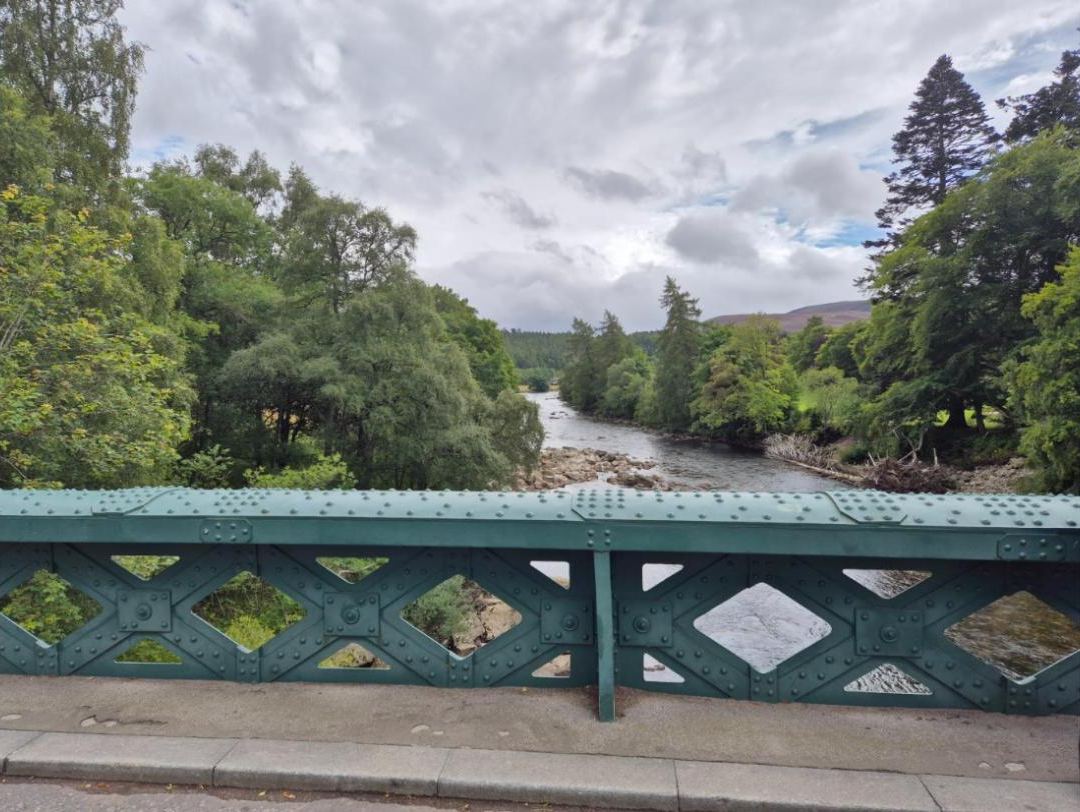 Green iron bridge over the river