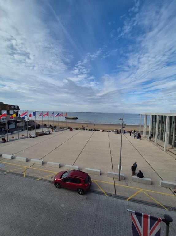 The square and flags above the beach