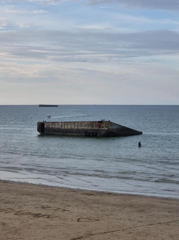 Part of the wartime Mulberry harbour off the beach